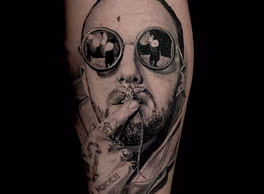 A black and grey realism portrait of artist/rapper Mac Miller done by owner and artist Eddie Holmes.